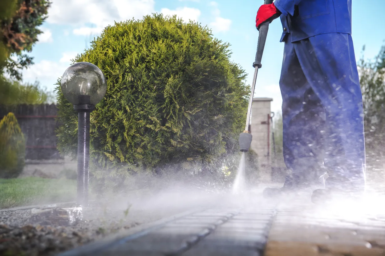 Power washing a residential driveway with controlled pressure
