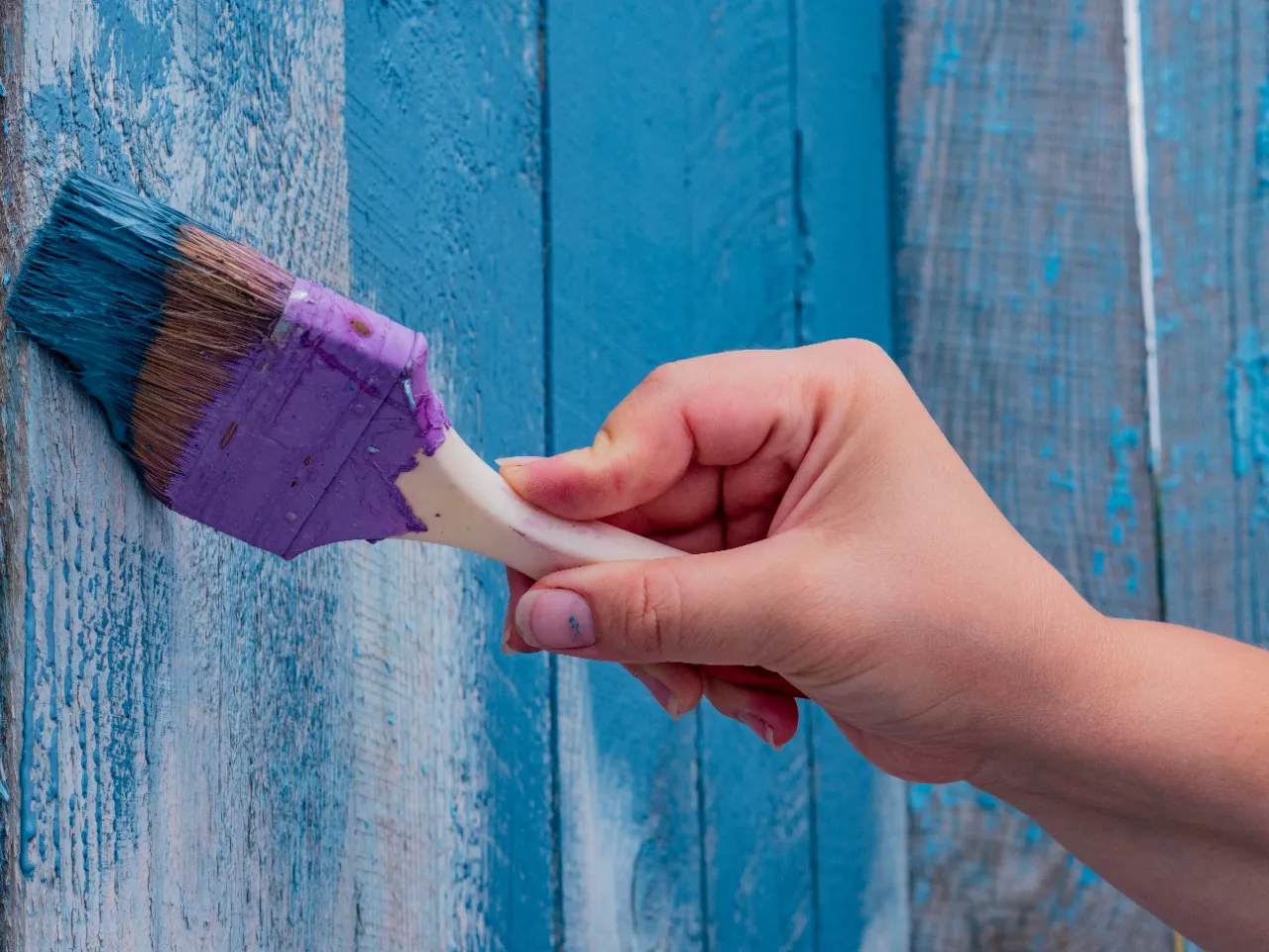 Hand painting a wooden wall in Waterbury, CT