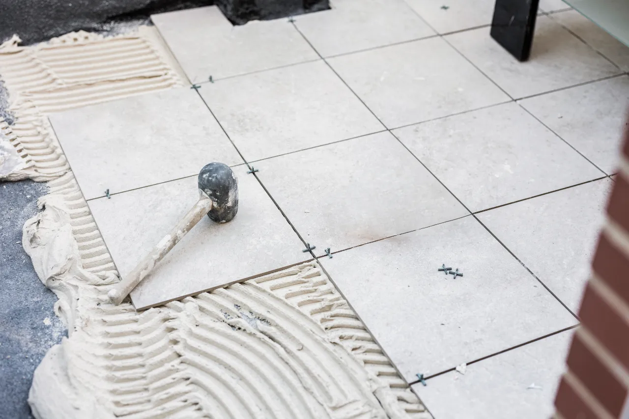 Ceramic tiles set with cement and rubber hammer in Greenwich, CT