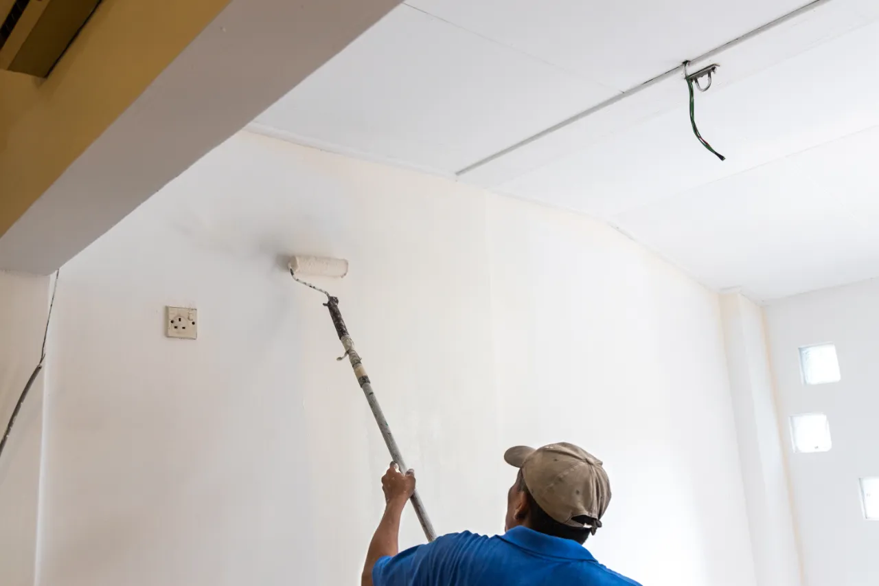 Interior walls being painted in a bright room