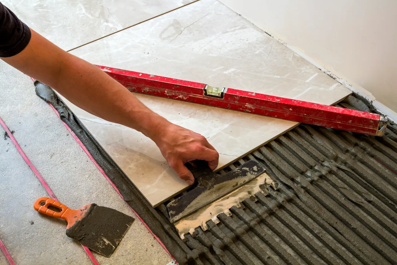 Tile floor set with a level in Hartford, CT